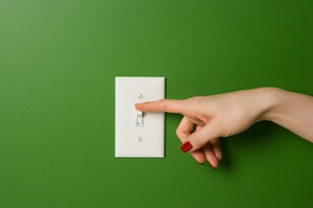 light switch on a green wall